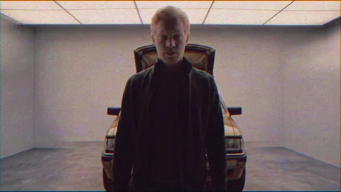 Shadowy person stands before car with open hood in dim garage Stock Footage 337134531