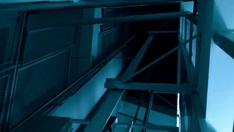 Shaft with elevator going up into darkness, conceptual for horror or thriller Stock Footage 81744735