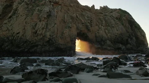 Shaft of Light through Keyhole Arch at Sunset, Big Sur Stock Footage 57930120