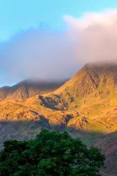 Shaft of sunlight on a mountain range Stock Photos