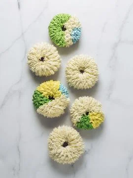 Shag donuts on white marble background. Unusual trendy colorful donuts with Stock Photos