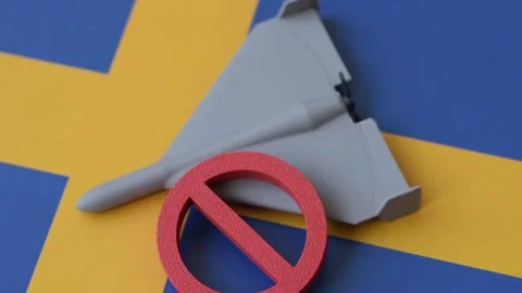 A Shahed drone featuring a prohibition symbol on the Sweden flag, conceptual bac Stock Footage 339440424