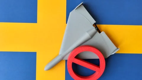A Shahed drone featuring a prohibition symbol on the Sweden flag, conceptual bac Stock Footage 339440689