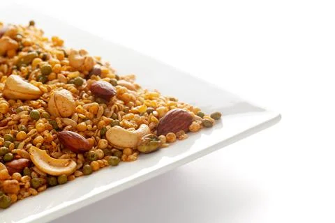 Shahi Mixture in  white ceramic square plate, having peanut, cashew, almonds Stock Photos