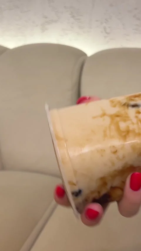 Shake bubble tea Female hands holding cup of hot beverage in light room. Slowly Stock Footage 302712430