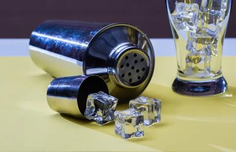 Shaker lying on yellow background Stock Photos
