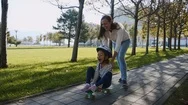 Shaking, Dynamic Video Of Mommy Pushing The Ldaughter On Skateboard, Steadicam. Stock Footage