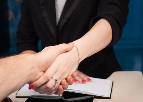 Shaking hands with client in office, closeup, conclusion, contract Foto stock