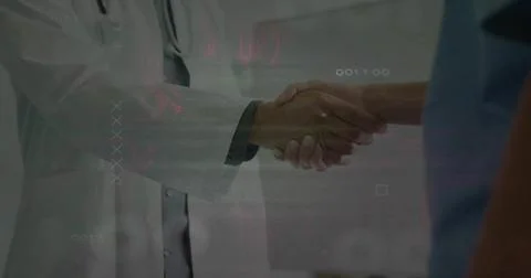 Shaking hands doctor in lab coat and nurse in blue scrubs in clinic, Stock Photos