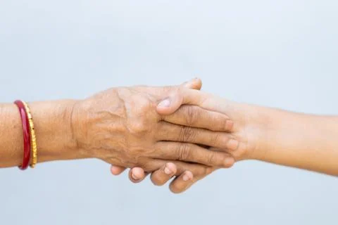 The shaking hands on a grey background - importance of avoiding handshakes du Stock Photos