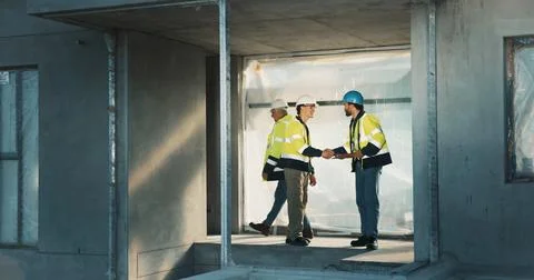 Shaking hands, team and construction workers at worksite for partnership Stock Photos