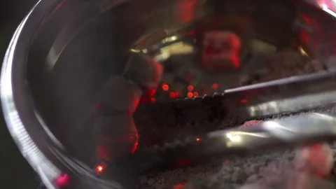 Shaking off of hookah coals in slow motion Stock Footage 81920243