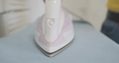 Shaking iron, micro stroking. Front view, close-up. Funny iron movement. Vídeos de archivo 233446092