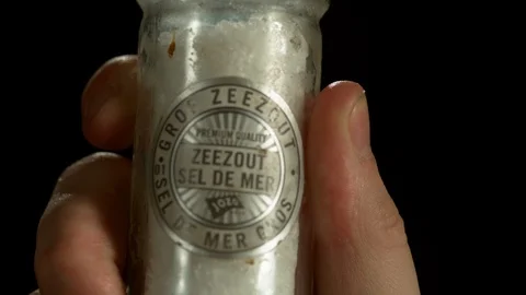 Shaking a jar of salt on a black background 4K 1000FPS Video stock 90898780