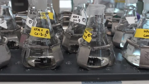 Shaking several beakers Stock Footage 106901805