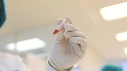 Shaking small red solution tube in laboratory slow motion Video stock 158916245