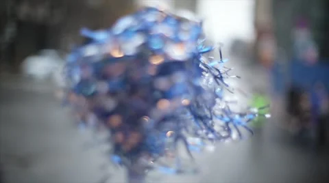 Shaking in someone's hands blue pom pom on street. Day. Sport event Stock Footage 62744825