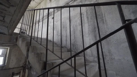 Shaky camera comes towards damaged staircase leading nowhere. Exploring of Stock Footage 109174213