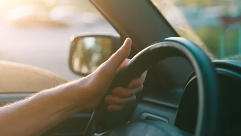 Shaky camera driver hand gripping steering wheel with intense frustration Stock Footage 314140794