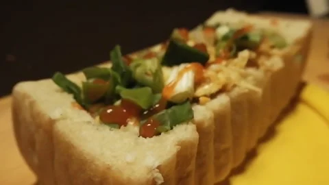 Shaky hand held raw footage of egg inside a hollow bread with sauce green onion Video stock 327588798