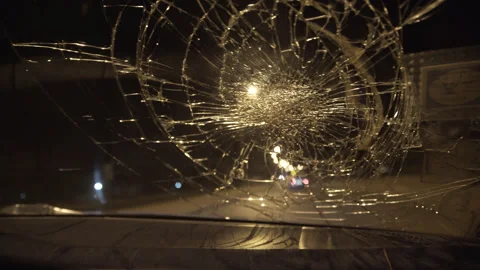 Shaky Handheld POV Shattered Windshield Night Car Interior Dramatic Stock Footage 335550406
