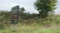 Shaky out of car window shot, driving past farms/ hedges HD Footage