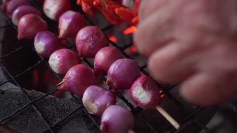 Shallot and red chilli on skewer getting grill on charcoal grill. hot fire under Video stock 120024016