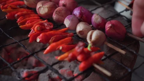 Shallot and red chilli on skewer getting grill on charcoal grill. hot fire under Video stock 120024043