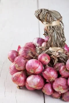 Shallot bundle on wooden table. Stock Photos
