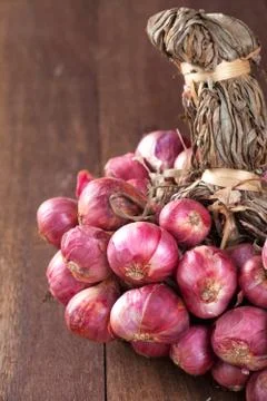 Shallot bundle on wooden table. Stock Photos