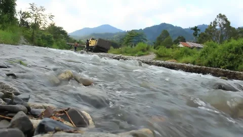 Shallow and rocky river. The river water flow is quite heavy, has a low depth Stock Footage 246428985