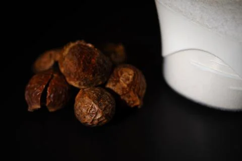 Shallow dark comparison between washing nuts and powder Stock Photos