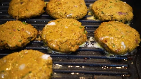 Shallow depth of feild shot mince meat mutton patties keema roasting on a pan Stock Footage 132638324