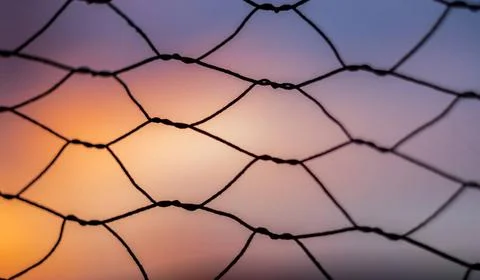 Shallow depth of field and close up on an old fence at sunrise with nice c... Stock Photos