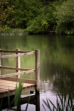 Shallow depth of field landscape image of vibrant peaceful Summer lake in E.. Stock Photos