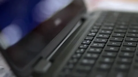 Shallow depth of field on a laptop playing generic movie animations Stock Footage 74253640