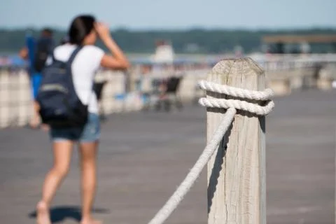 Shallow depth of field looking past railing post overlooking boardwalk along  Stock Photos
