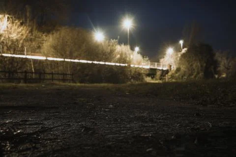 A shallow depth of field, low angle shot of street lights and traffic trails Stock Photos