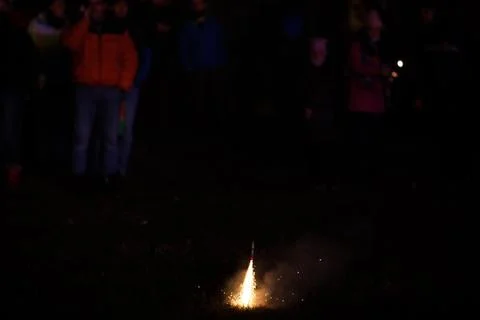 Shallow depth of field (selective focus) details with people lighting firecra Stock Photos