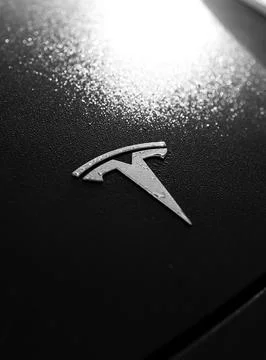 Shallow depth of field (selective focus) details with the Tesla logo on the.. Stock Photos