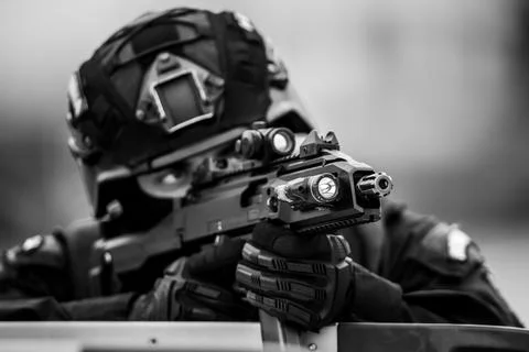 Shallow depth of field (selective focus) details with a weapon being aimed .. Stock Photos