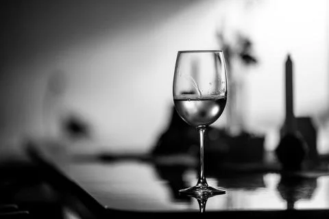 Shallow depth of field (selective focus) details with a glass of white wine.. Stock Photos