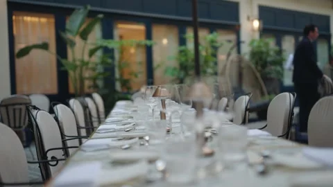 Shallow depth of field shot of a long elegantly set dining table with Stock Footage 333675997