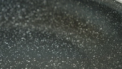 Shallow DOF focus pulling on pan surface 4K video Stock Footage 230538371