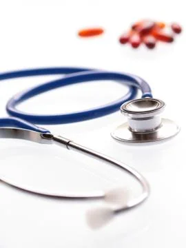 A shallow DOF image of a stethoscope on white background. Stock Photos