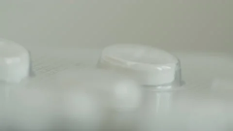Shallow DOF white tablets in silver package 4K footage Stock Footage 172326151