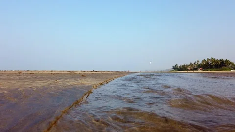 Shallow fast river surface and a beach house among the coconut trees Stock Footage 128839457