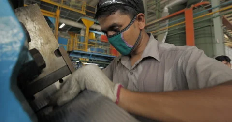 Shallow Focus and Medium Shot of Worker Using Industrial Equipment (4K) Stock Footage 60761901