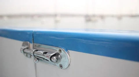 Shallow Focus - Chrome Latch on Rocking Boat door Stock Footage 2166282