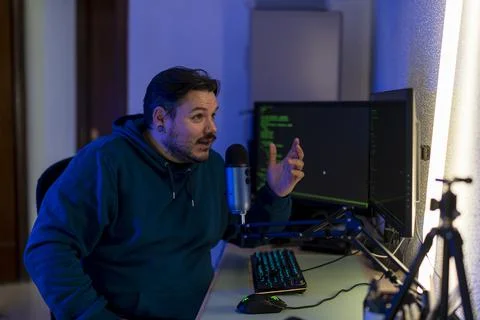 Shallow focus of a computer programming instructor teaching remotely through a c Stock Photos